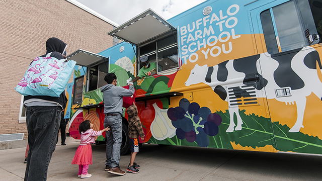 Hungry customers outside the West Hertel Academy place their orders at the new Buffalo Public Schools’ food truck.