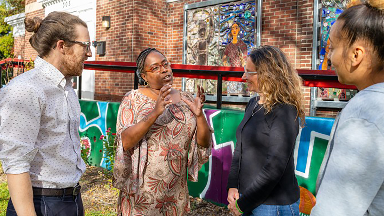 People talk outside the Southside Community Center in Ithaca, New York.