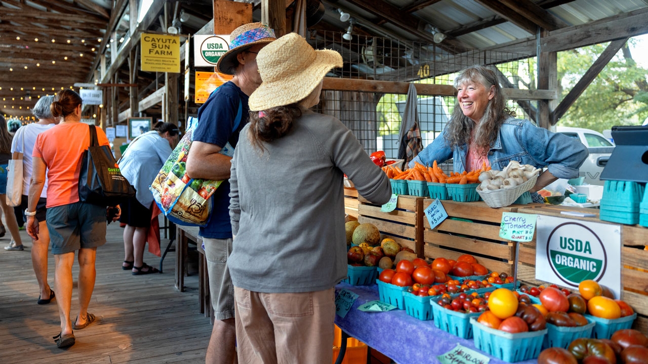 Mary McGarry-Newman sells organic heirloom tomatoes, garlic and other vegetables and fruits at the Ithaca Farmers Market.